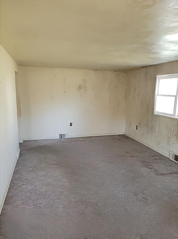 empty room with visible vents and concrete flooring