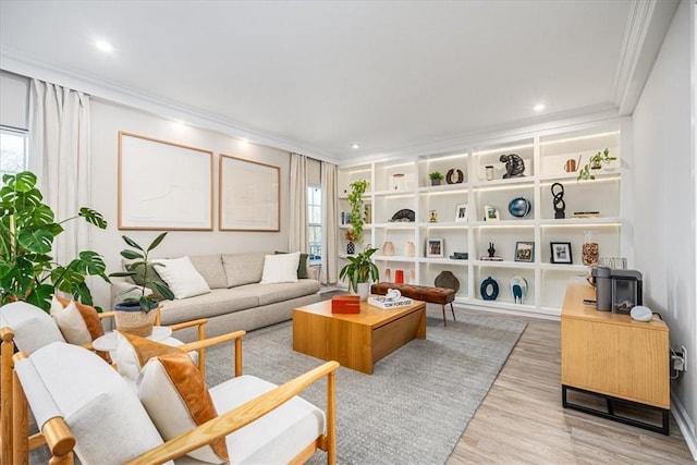 living room featuring a wealth of natural light, recessed lighting, wood finished floors, and ornamental molding