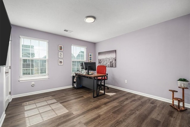 office featuring visible vents, baseboards, and wood finished floors