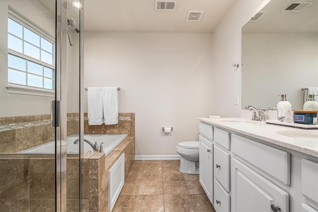 bathroom featuring double vanity, a bath, visible vents, and a sink