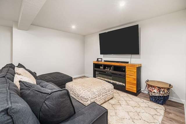 living area with recessed lighting, baseboards, and wood finished floors