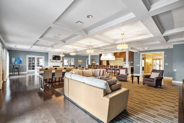 living room featuring dark wood-type flooring, baseboards, coffered ceiling, and visible vents