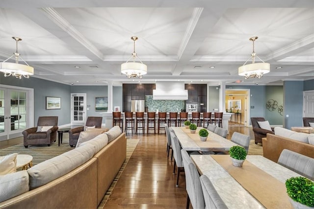 interior space with beamed ceiling, wood finished floors, coffered ceiling, and a notable chandelier