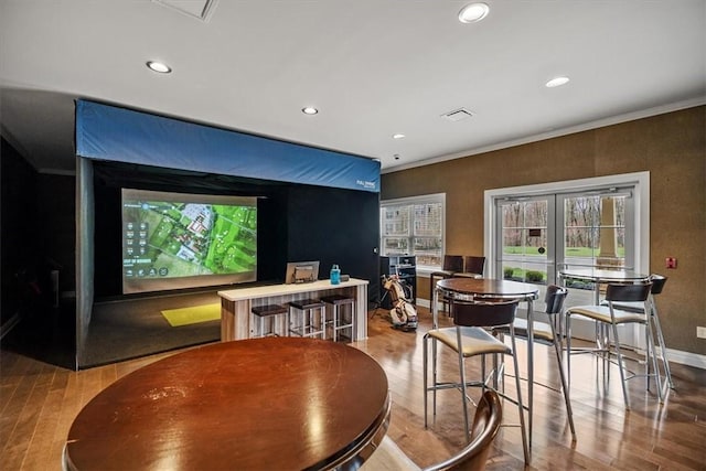 interior space featuring visible vents, baseboards, ornamental molding, wood finished floors, and recessed lighting