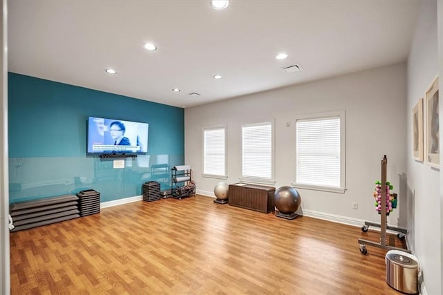 workout area featuring recessed lighting, baseboards, visible vents, and wood finished floors