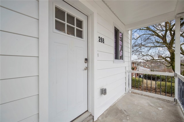 view of exterior entry featuring covered porch