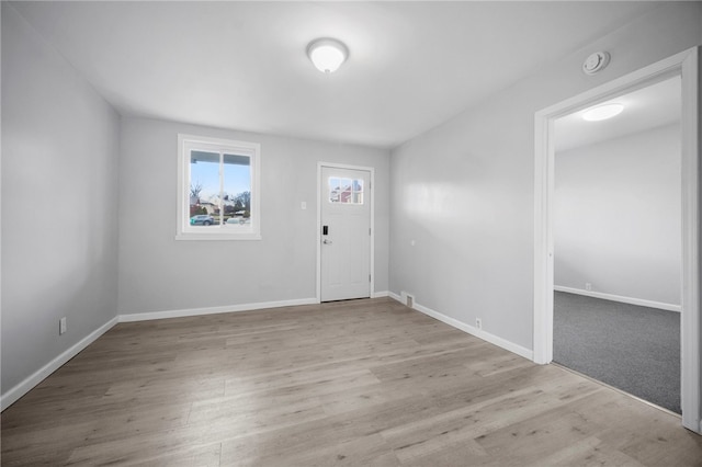 entrance foyer with baseboards and wood finished floors