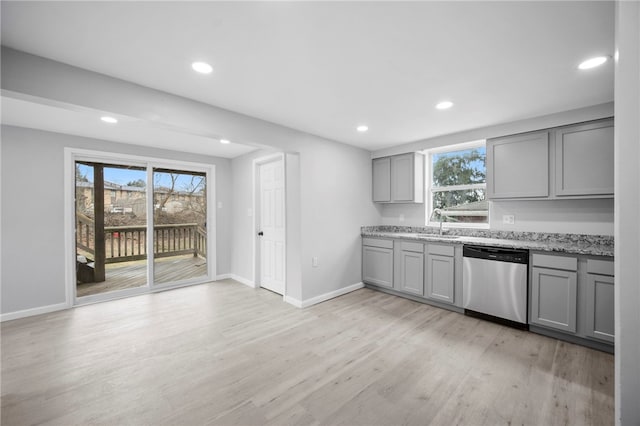 kitchen featuring plenty of natural light, light wood-style flooring, gray cabinetry, and stainless steel dishwasher