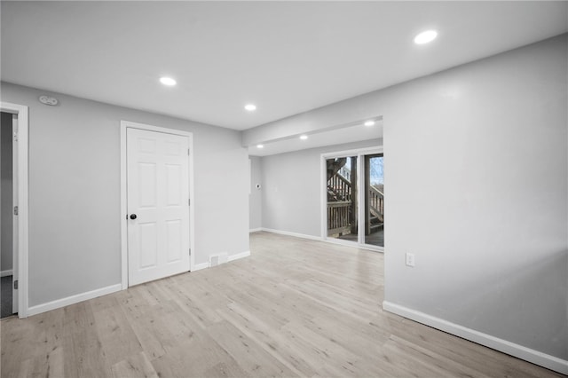 below grade area with visible vents, recessed lighting, wood finished floors, and baseboards