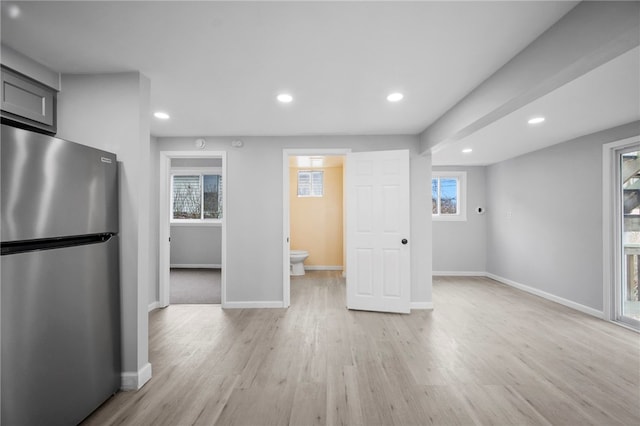 kitchen featuring recessed lighting, light wood-type flooring, baseboards, and freestanding refrigerator