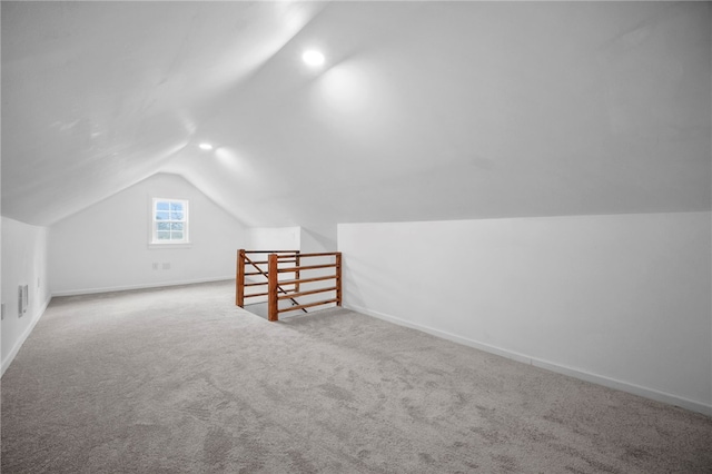 bonus room featuring vaulted ceiling, baseboards, and carpet floors