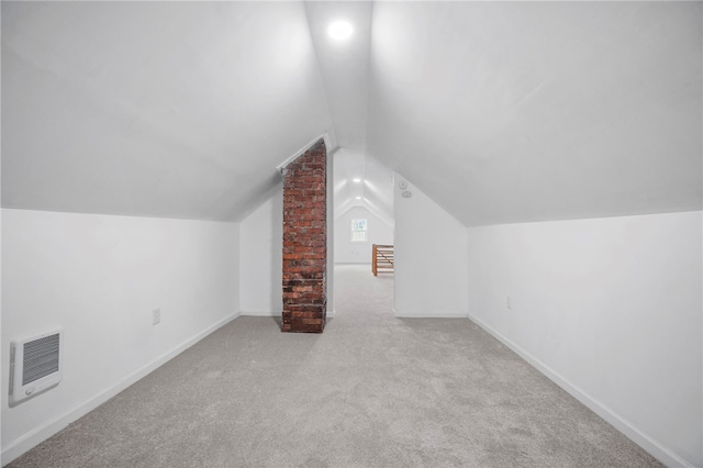 additional living space featuring heating unit, carpet flooring, baseboards, and lofted ceiling