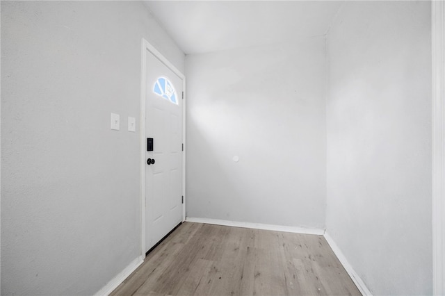 entryway with baseboards and light wood-style floors