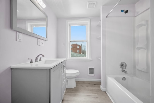 full bathroom with vanity, toilet, visible vents, and a wealth of natural light