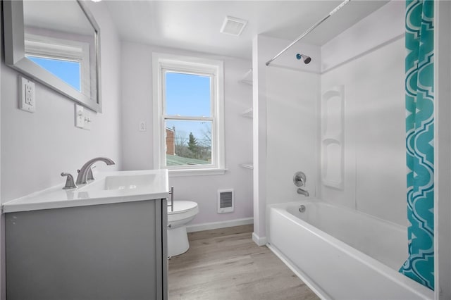 bathroom featuring visible vents, toilet, shower / bath combo, wood finished floors, and vanity