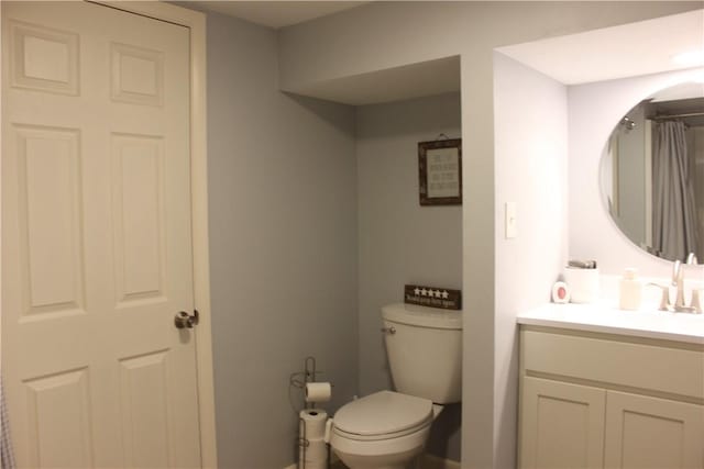 bathroom with toilet and vanity