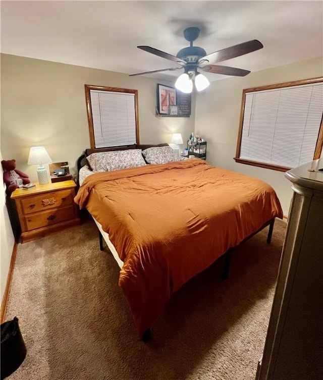 bedroom featuring a ceiling fan and carpet