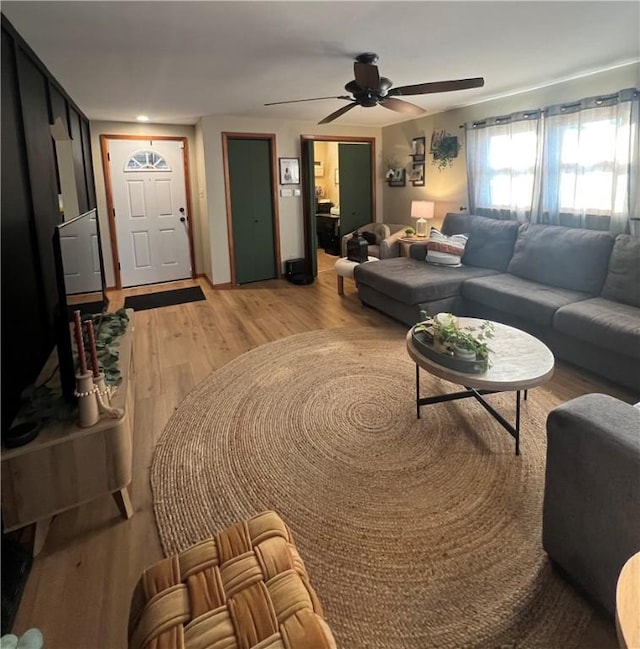 living room with light wood-type flooring and ceiling fan