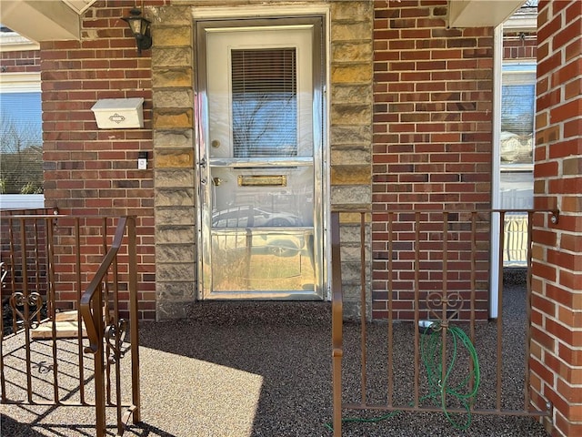 doorway to property with brick siding