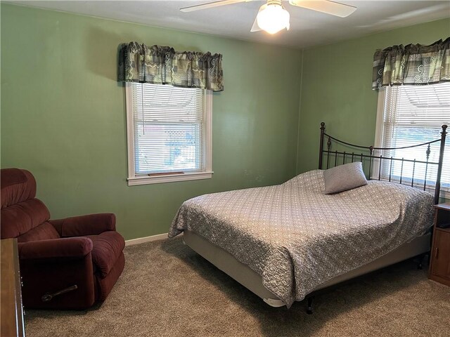 carpeted bedroom with baseboards and a ceiling fan