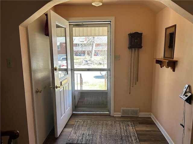 entryway featuring dark wood finished floors, baseboards, and visible vents