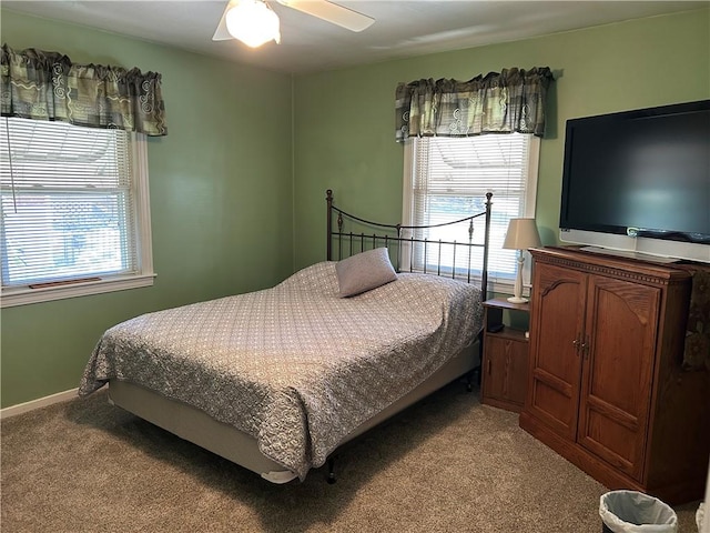 bedroom featuring light colored carpet, baseboards, and ceiling fan