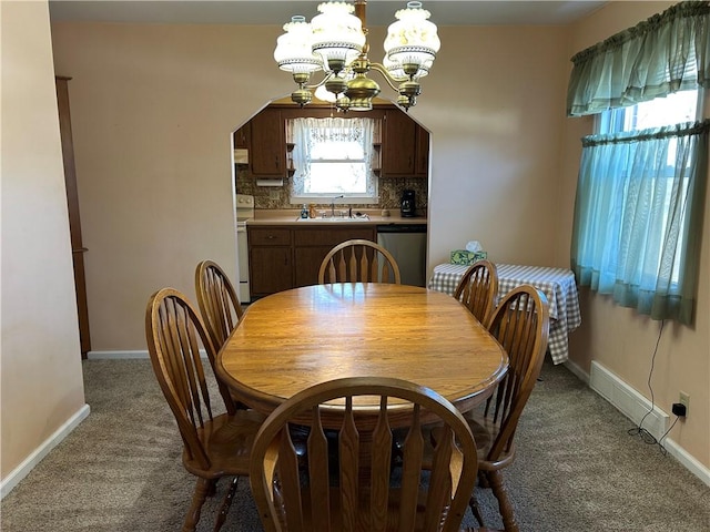 dining room with baseboards, carpet floors, and a chandelier