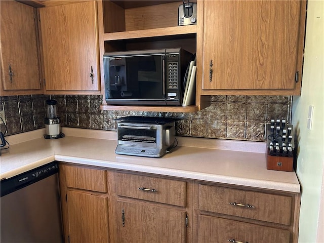 kitchen featuring tasteful backsplash, black microwave, a toaster, dishwasher, and light countertops