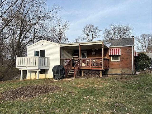 back of property featuring a lawn, a shingled roof, a wooden deck, brick siding, and a chimney