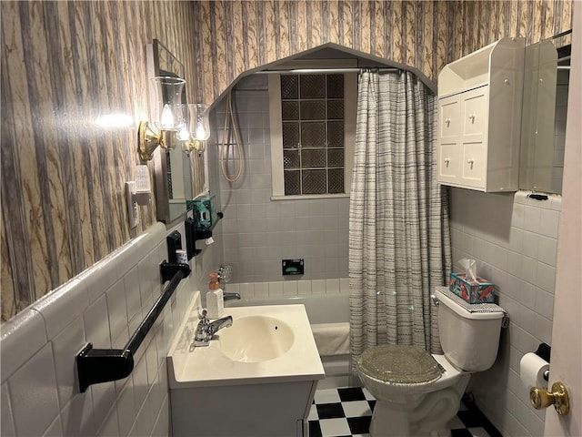 full bathroom featuring vanity, wallpapered walls, tile walls, toilet, and tile patterned floors