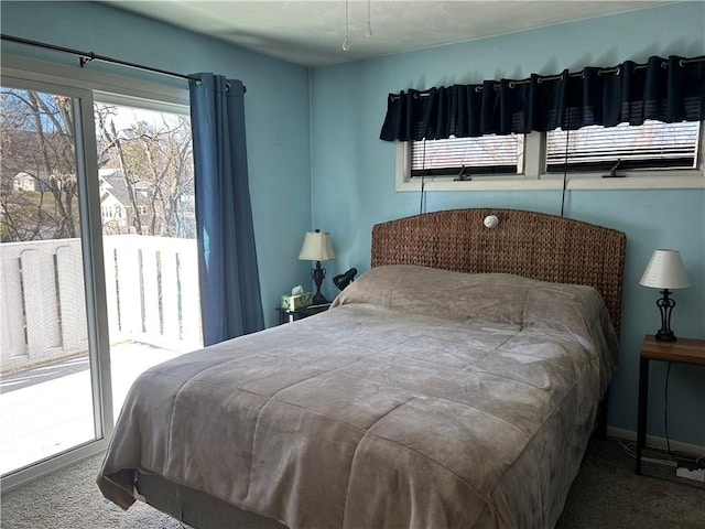 bedroom featuring access to exterior and carpet flooring