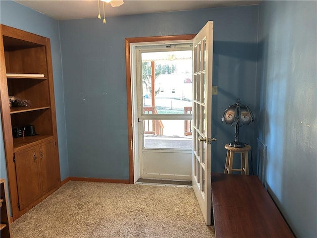 entryway featuring a healthy amount of sunlight, french doors, light colored carpet, and baseboards