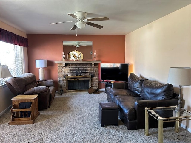 living room with baseboards, carpet floors, a ceiling fan, and a fireplace