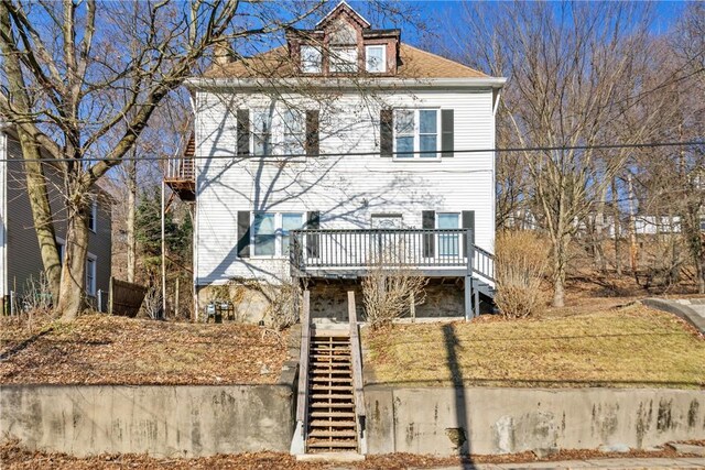 view of front of house with stairs and a deck