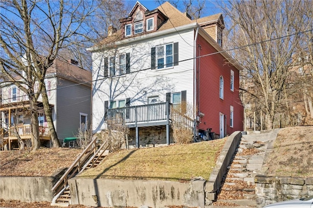 view of front of house featuring stairway and a deck