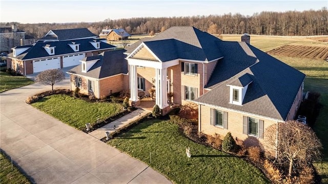 view of front of house featuring a front yard, driveway, and a chimney