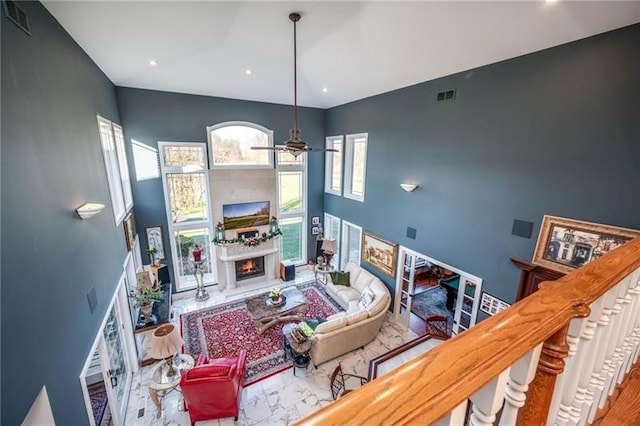 4605 Whippoorwill Dr, Hermitage, PA 16148 - living area featuring a lit fireplace, a towering ceiling, ceiling fan, and recessed lighting