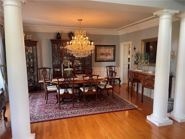 4605 Whippoorwill Dr, Hermitage, PA 16148 - dining room with decorative columns, wood finished floors, ornamental molding, a chandelier, and wainscoting