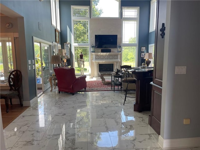 4605 Whippoorwill Dr, Hermitage, PA 16148 - living room with a fireplace, a towering ceiling, and light marble finish flooring
