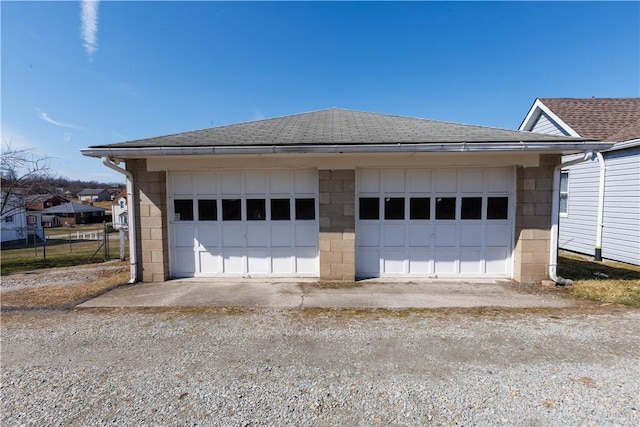 detached garage featuring fence