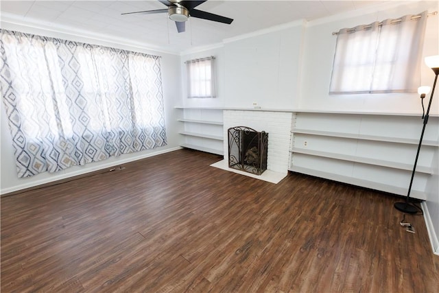 unfurnished living room with ornamental molding, a ceiling fan, dark wood-style floors, a fireplace, and baseboards