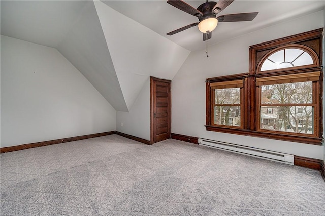 bonus room featuring baseboards, light carpet, baseboard heating, and vaulted ceiling