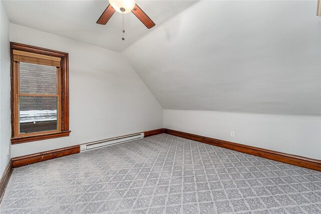 bonus room with a ceiling fan, baseboards, a baseboard radiator, lofted ceiling, and light carpet