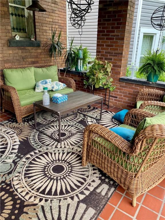 balcony with an outdoor living space and a patio