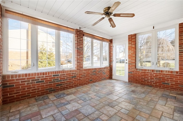 unfurnished sunroom featuring ceiling fan and wooden ceiling