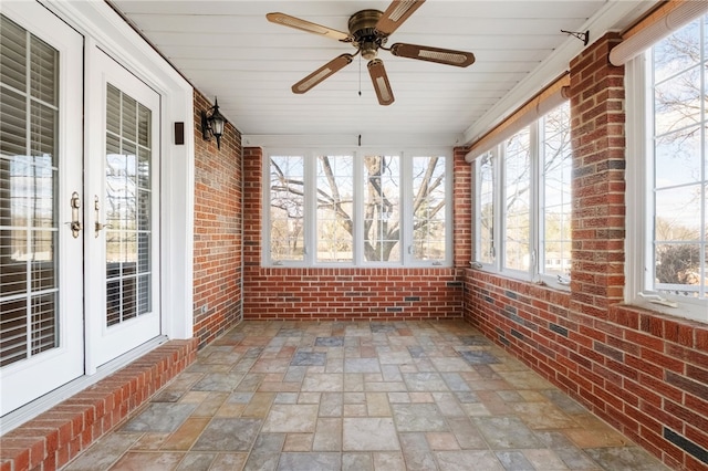 unfurnished sunroom featuring visible vents and a ceiling fan