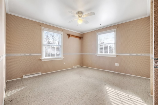 spare room featuring a wealth of natural light, visible vents, wallpapered walls, and ornamental molding