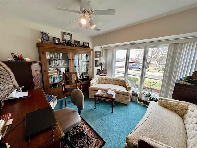 living area featuring visible vents, ceiling fan, and carpet