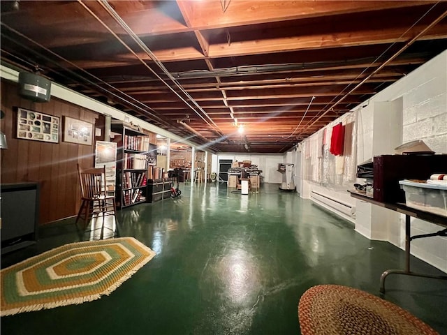 unfinished basement featuring concrete block wall