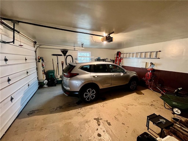 garage with gas water heater and a garage door opener